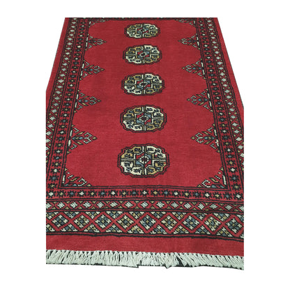 End field and border detail of Bokhara hand-knotted rug showing oval gul motifs, red ground and geometric border work