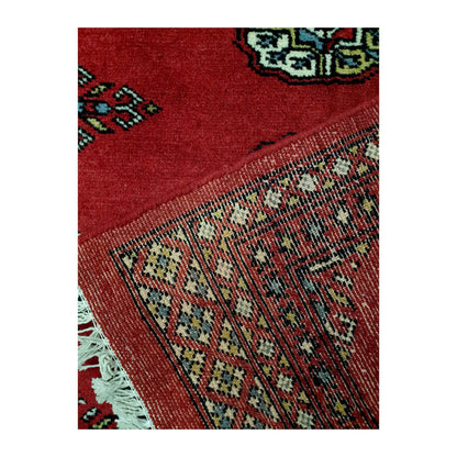 Folded corner reverse-weave detail of Bokhara hand-knotted wool rug showing back structure, border pattern and weave