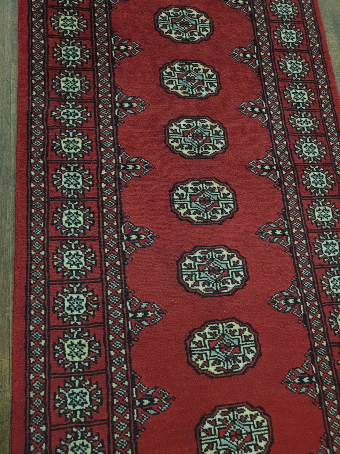 Bokhara hand-knotted wool runner rug 249 x 77 cm field and border detail