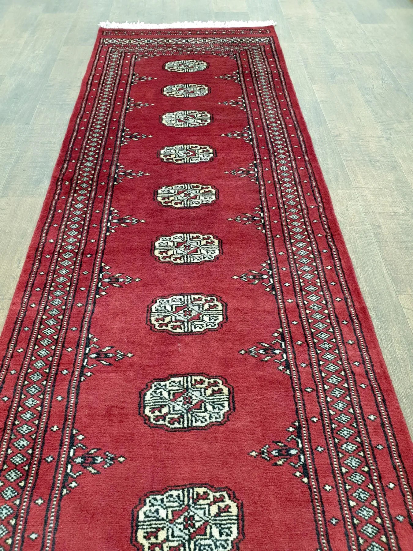 Bokhara runner rug length view showing repeating design
