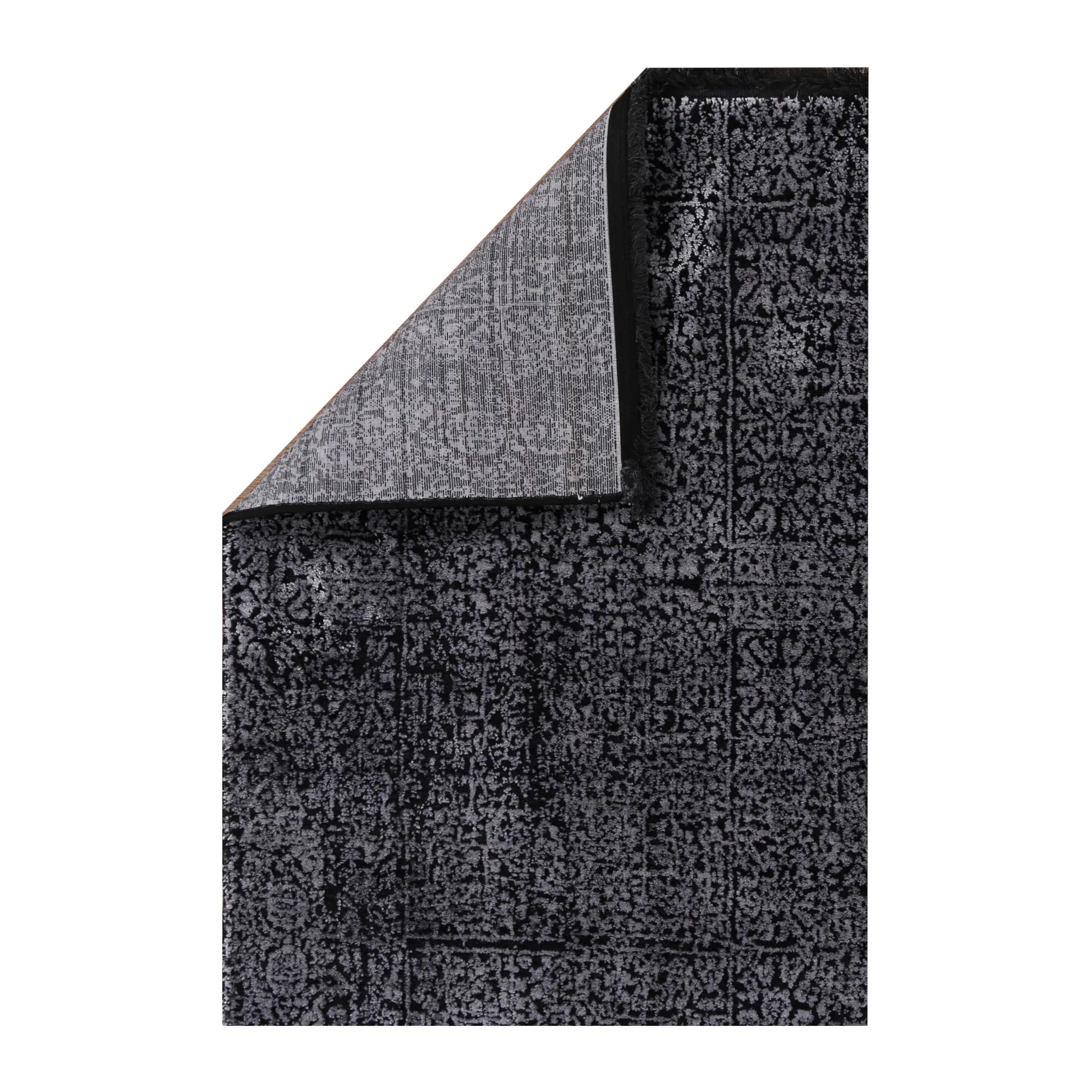 Folded corner detail of Brooklyn 100 silver mosaic rug showing edge and backing texture