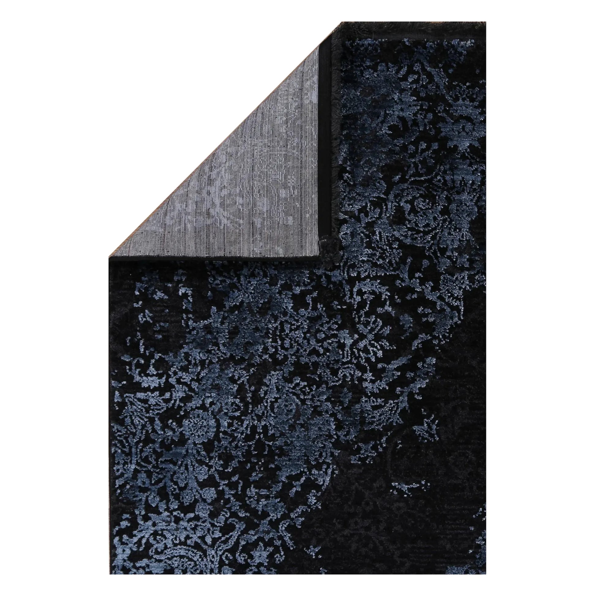Folded corner detail of Brooklyn 400 blue medallion rug showing backing and edge texture