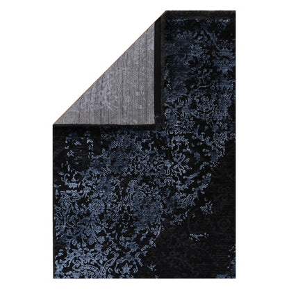 Folded corner detail of Brooklyn 400 blue medallion rug showing backing and edge texture