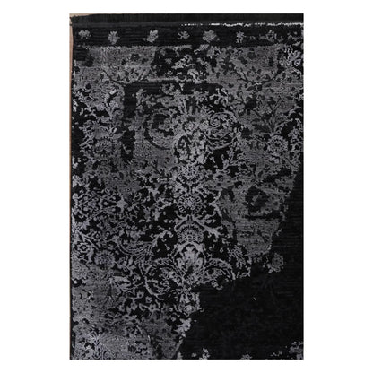 Close view of the raised silver-grey floral pattern and deep black field