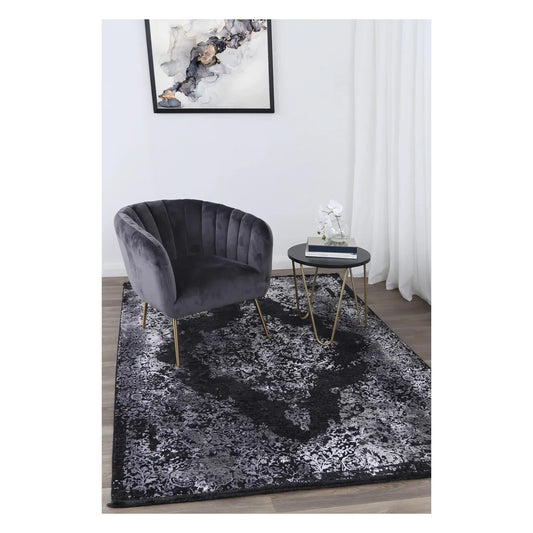 Brooklyn 400 silver medallion modern rug styled with a charcoal chair and round side table