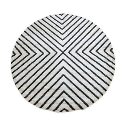 Full view of Primo charcoal and ivory round rug with converging diamond-line pattern, 160 cm diameter