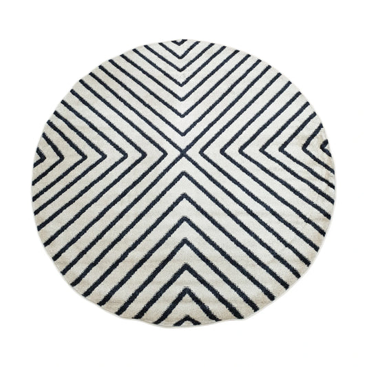 Full view of Primo charcoal and ivory round rug with converging diamond-line pattern, 160 cm diameter