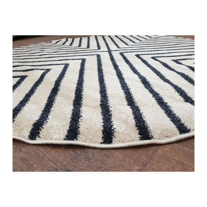 Low-angle close-up of charcoal round rug showing surface texture and diamond line design, 160 cm