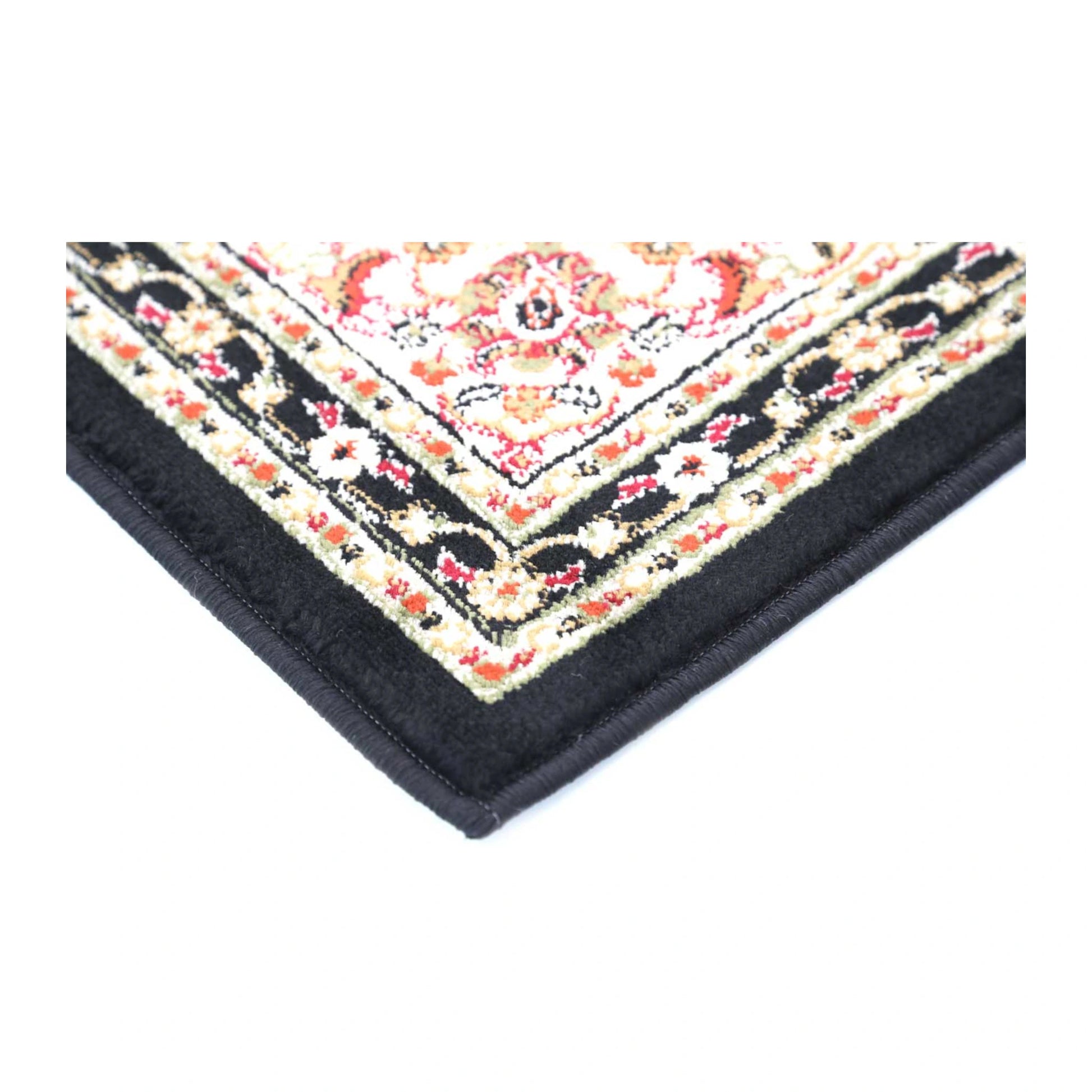 Corner detail of Classica black medallion rug showing floral border and bound edge