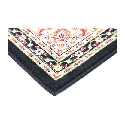 Corner detail of Classica black medallion rug showing floral border and bound edge
