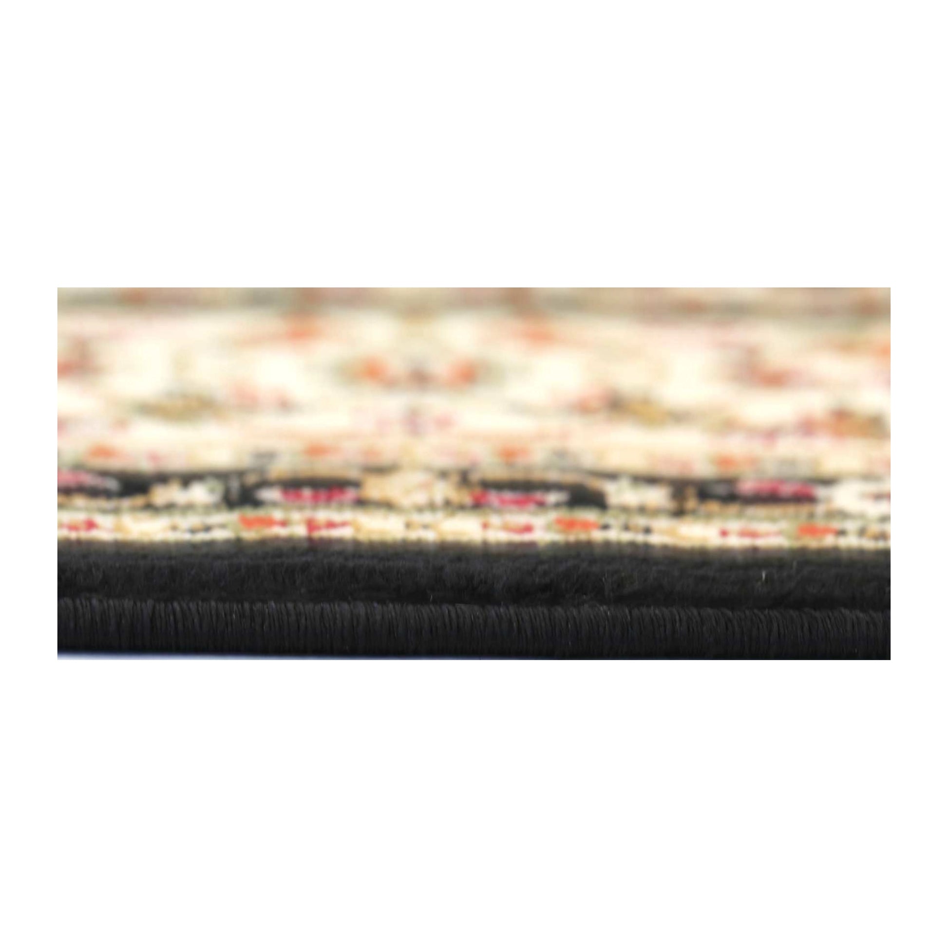 Edge detail of Classica black medallion rug showing pile thickness and woven edge