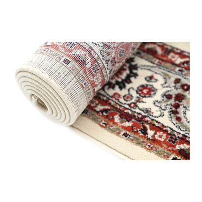 Rolled detail of Classica cream floral rug showing surface pattern and backing
