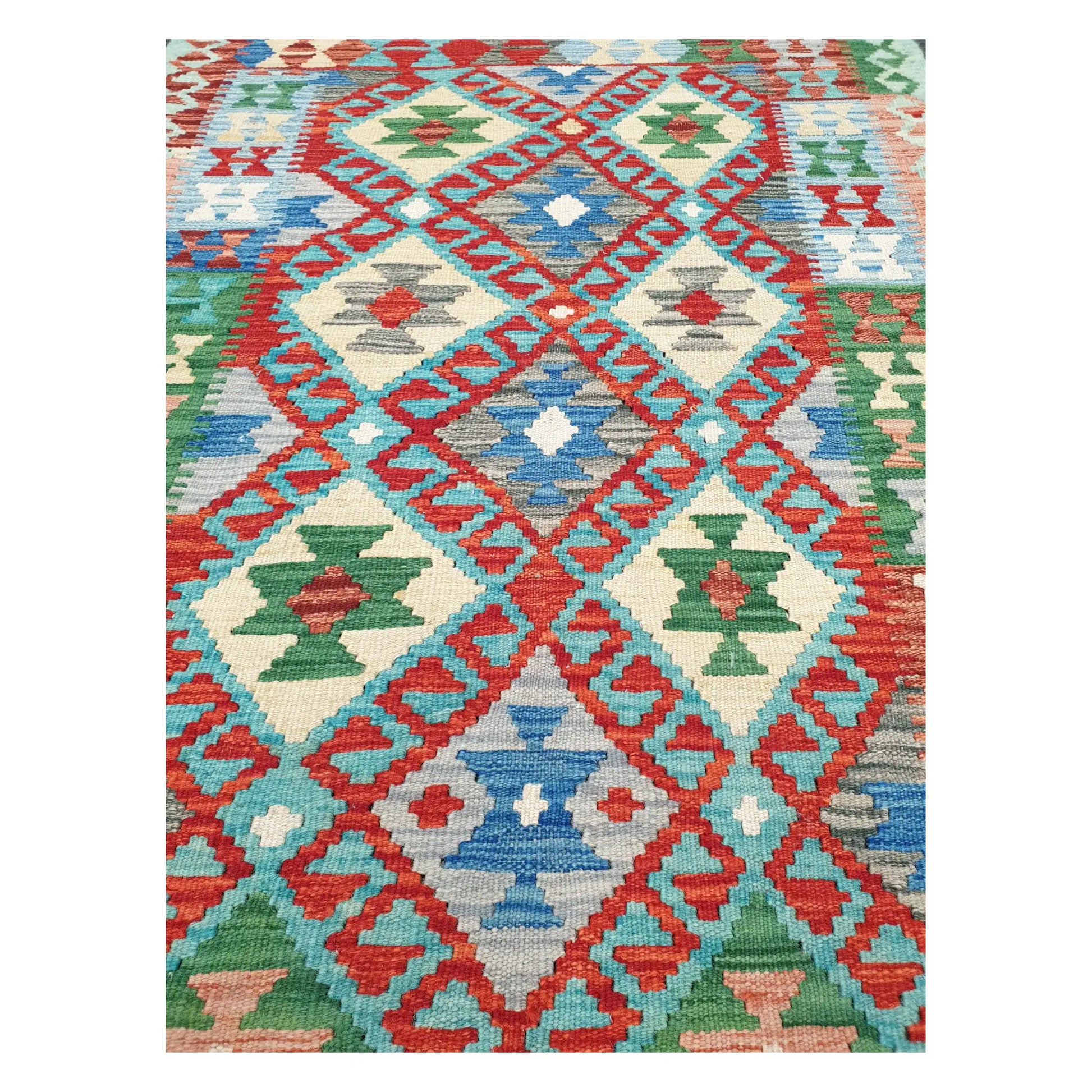 Close-up of Chobi Kilim rug with coral lattice, blue diamond medallions, and green geometric motifs, 156 x 106 cm