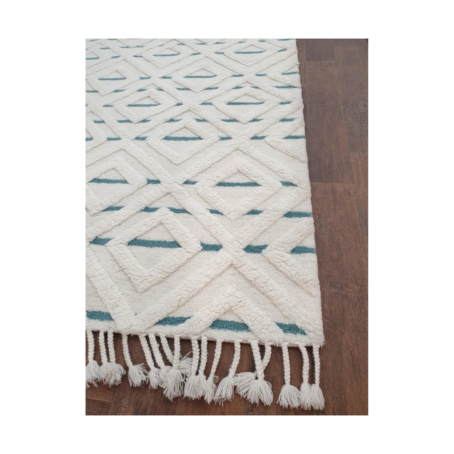 Close-up of cream blue hand-tufted wool rug showing fringe and edge finish