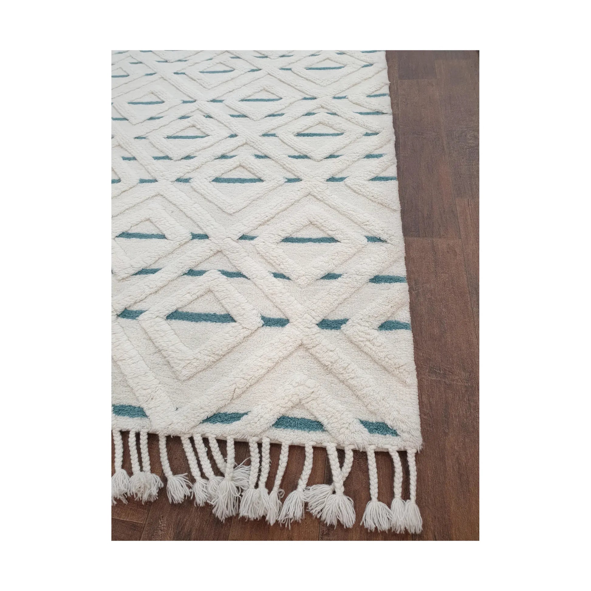 Close-up of cream blue hand-tufted wool rug showing fringe and edge finish