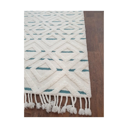 Close-up of cream blue hand-tufted wool rug showing fringe and edge finish