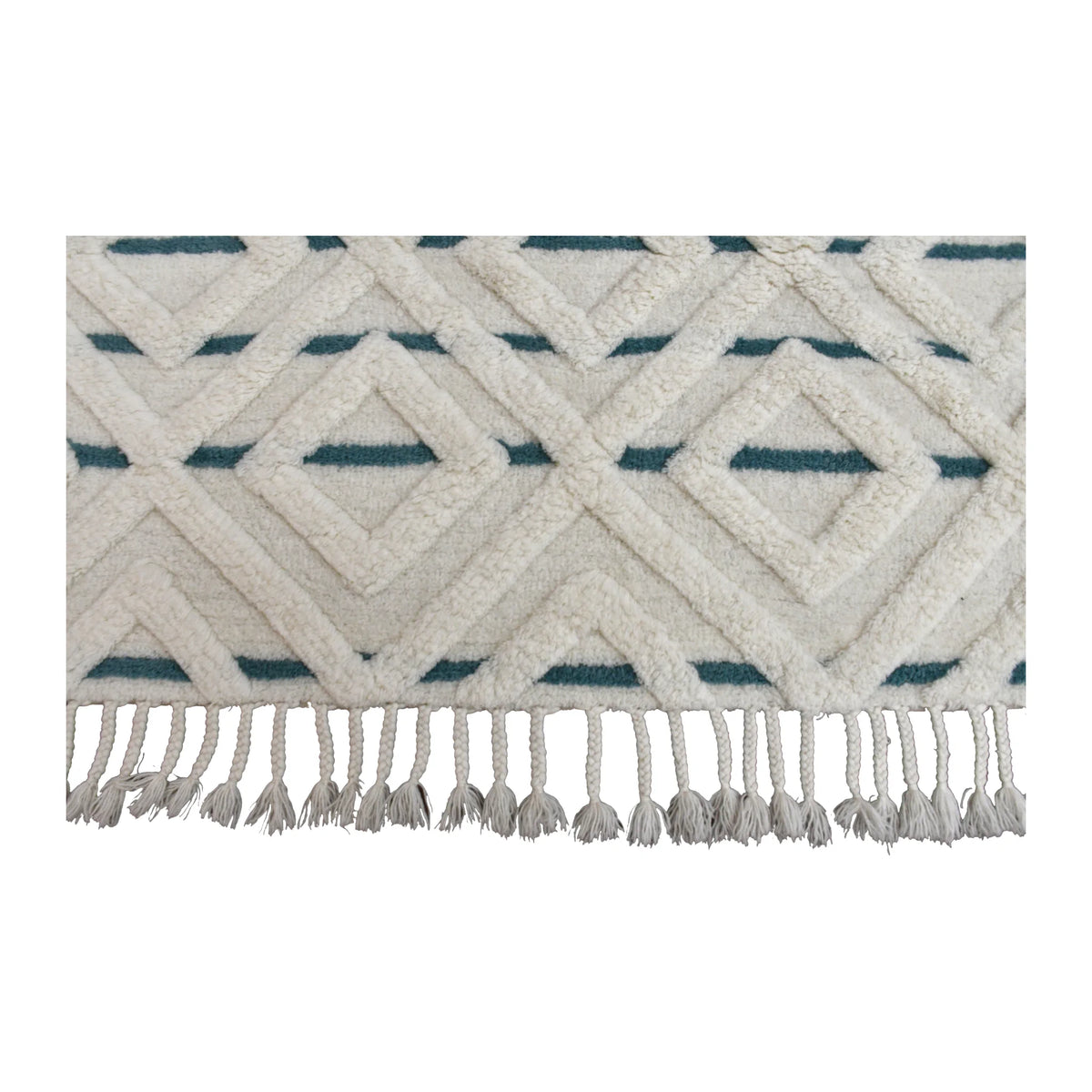 Fringe detail of hand-tufted wool rug with raised cream diamonds, muted blue accents and knotted tassels