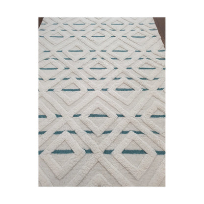 Close-up of cream blue geometric wool rug showing raised pattern and pile detail