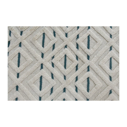 Field detail of cream wool rug showing an interlocking raised diamond lattice with muted blue geometric accents