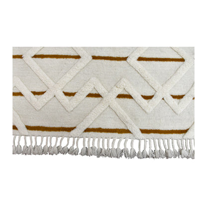 Fringe and end-pattern detail of hand-tufted wool rug with raised cream diamonds, mustard bands and knotted tassels