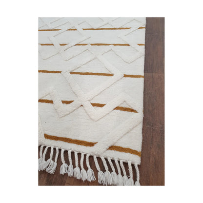 Close-up of cream mustard wool rug showing geometric pattern detail