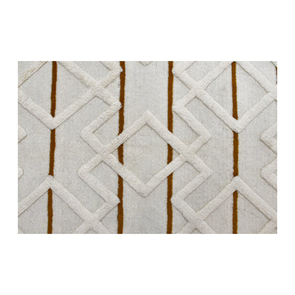 Field detail of cream wool rug showing an overlapping raised diamond lattice crossed by slim mustard lines
