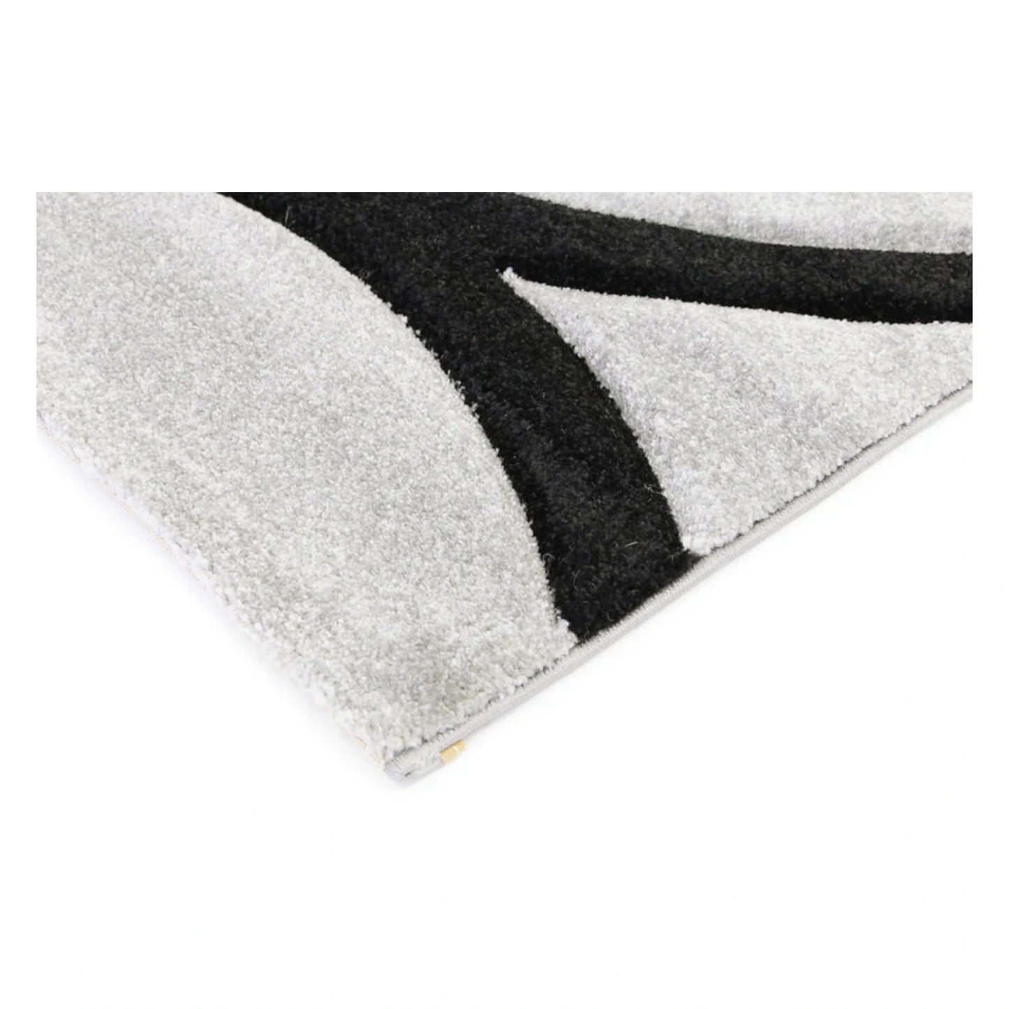 Corner detail of Diamond grey black swirl rug showing black raised pattern and grey pile