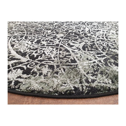 Low-angle close-up of emerald and charcoal round rug showing surface texture and patterned finish, 160 cm