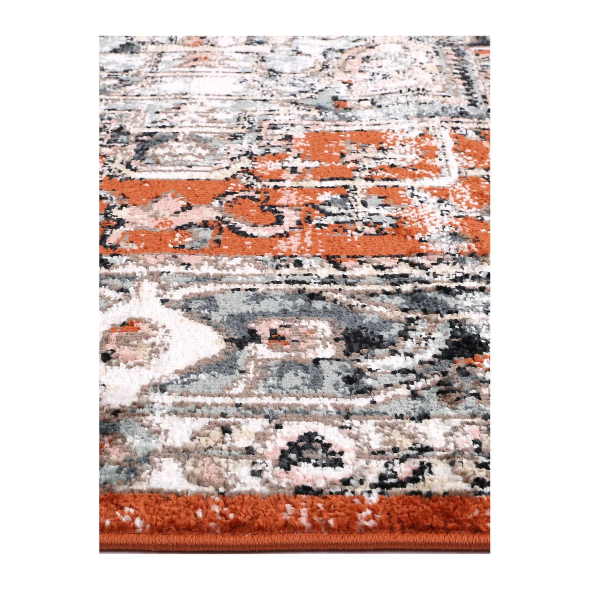 Close-up of Estate Terracotta rug showing textured polypropylene pile and terracotta, ivory and blue-grey pattern details