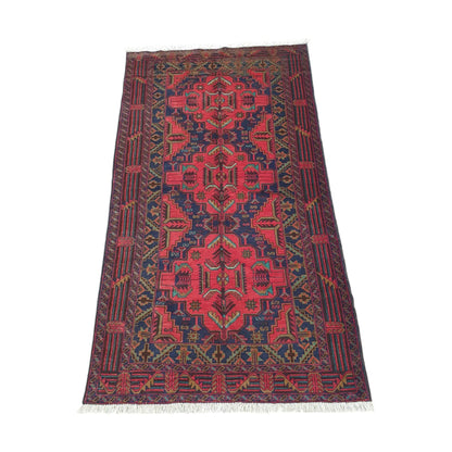 Angled full view of Afghan Baluchi wool rug with dark border and geometric motifs