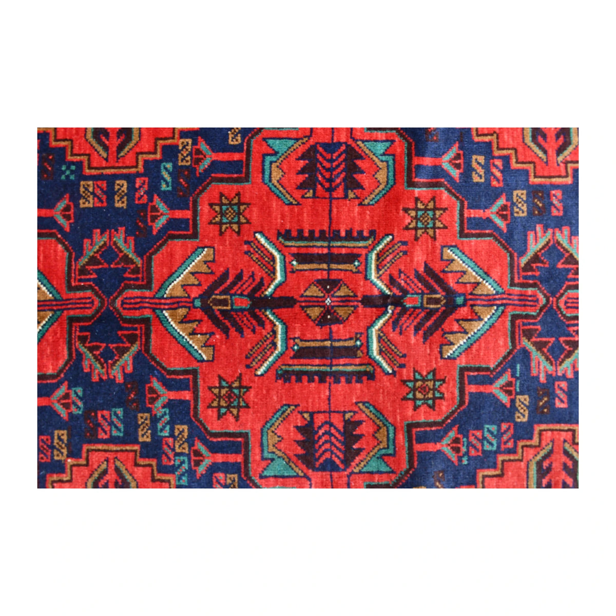 Central motif detail of Baluchi wool rug with deep red, teal, ochre and ivory patterning