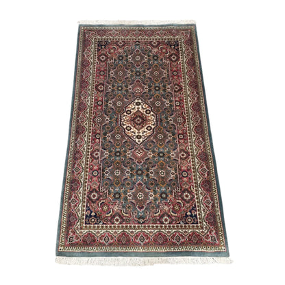 Angled full view of Fine Bidjar wool rug showing the central medallion, floral field and patterned borders