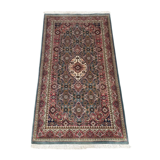Angled full view of Fine Bidjar wool rug showing the central medallion, floral field and patterned borders
