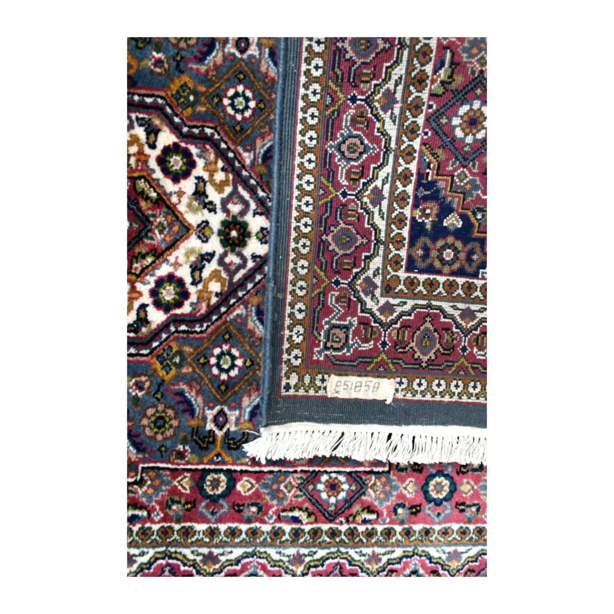 Folded-corner detail of Fine Bidjar rug showing the patterned reverse beside its floral front, border and cream fringe