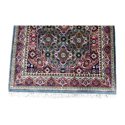 Fringe-end detail of Fine Bidjar rug showing rosettes and curved leaves above layered floral borders and cream fringe