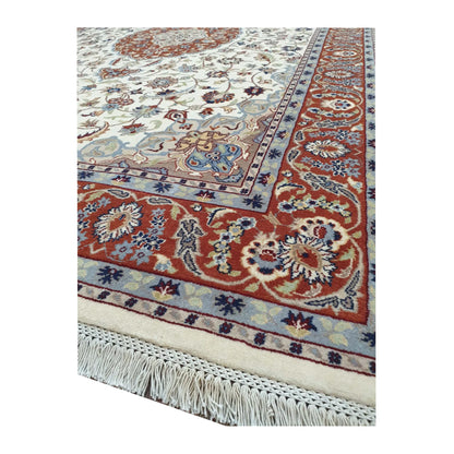 Border corner and fringe detail of Fine Tabriz rug showing the red floral pattern and blue accents