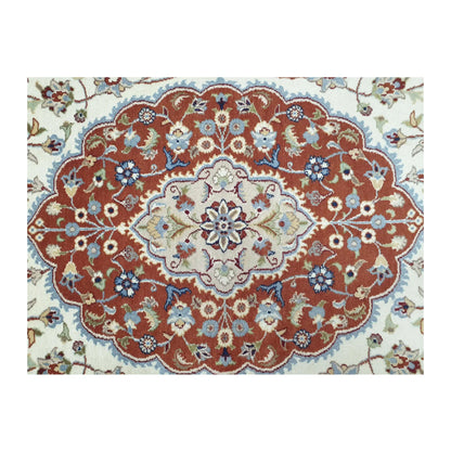 Close-up of Fine Tabriz wool rug central medallion showing layered red, beige and blue floral details