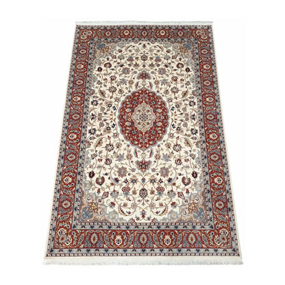 Angled full view of Fine Tabriz wool rug showing the beige floral field, red medallion and patterned border