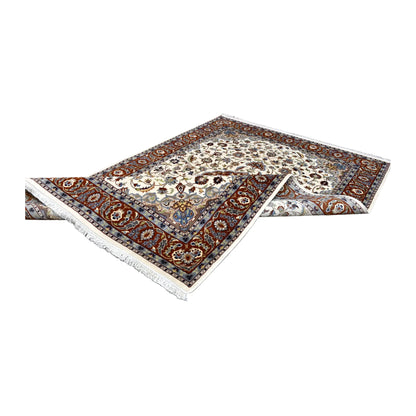Angled view of the Fine Tabriz rug partly folded, showing its floral front and patterned reverse at the sides