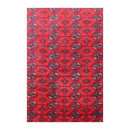 Field detail of the Fine Turkmen Tekke rug showing repeated dark guls and smaller motifs across the red wool pile