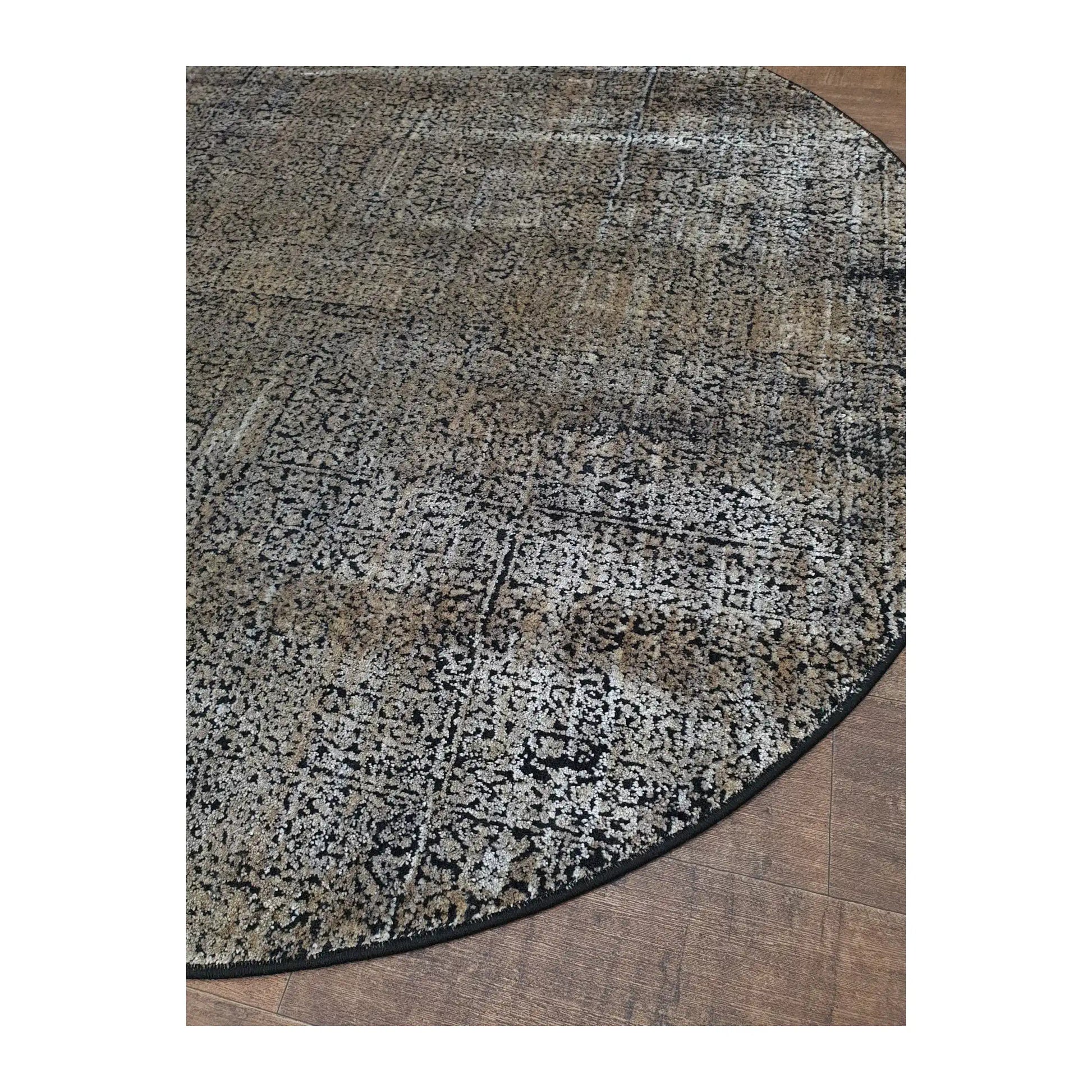 Angled detail of gold and taupe round rug showing textured pattern and edge finish, 160 cm