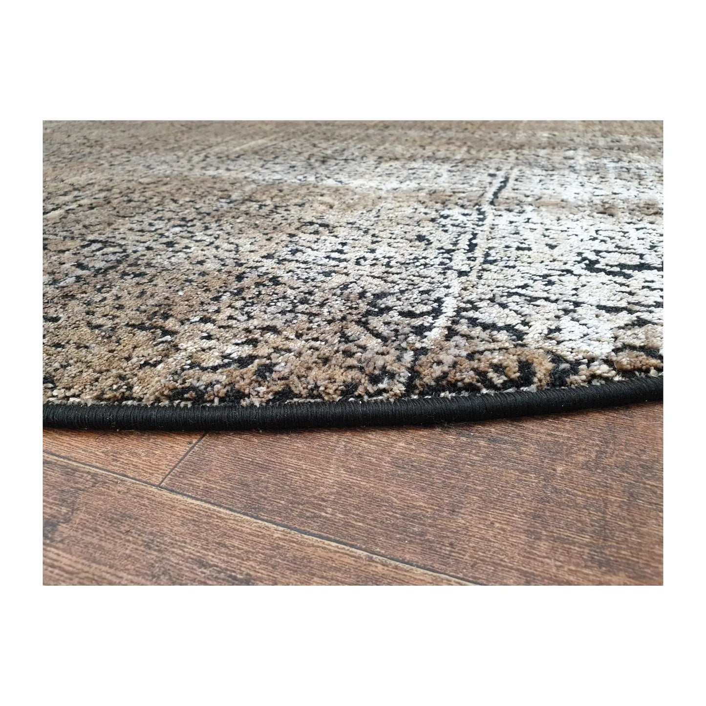 Low-angle close-up of gold and taupe round rug showing surface texture and abstract design, 160 cm