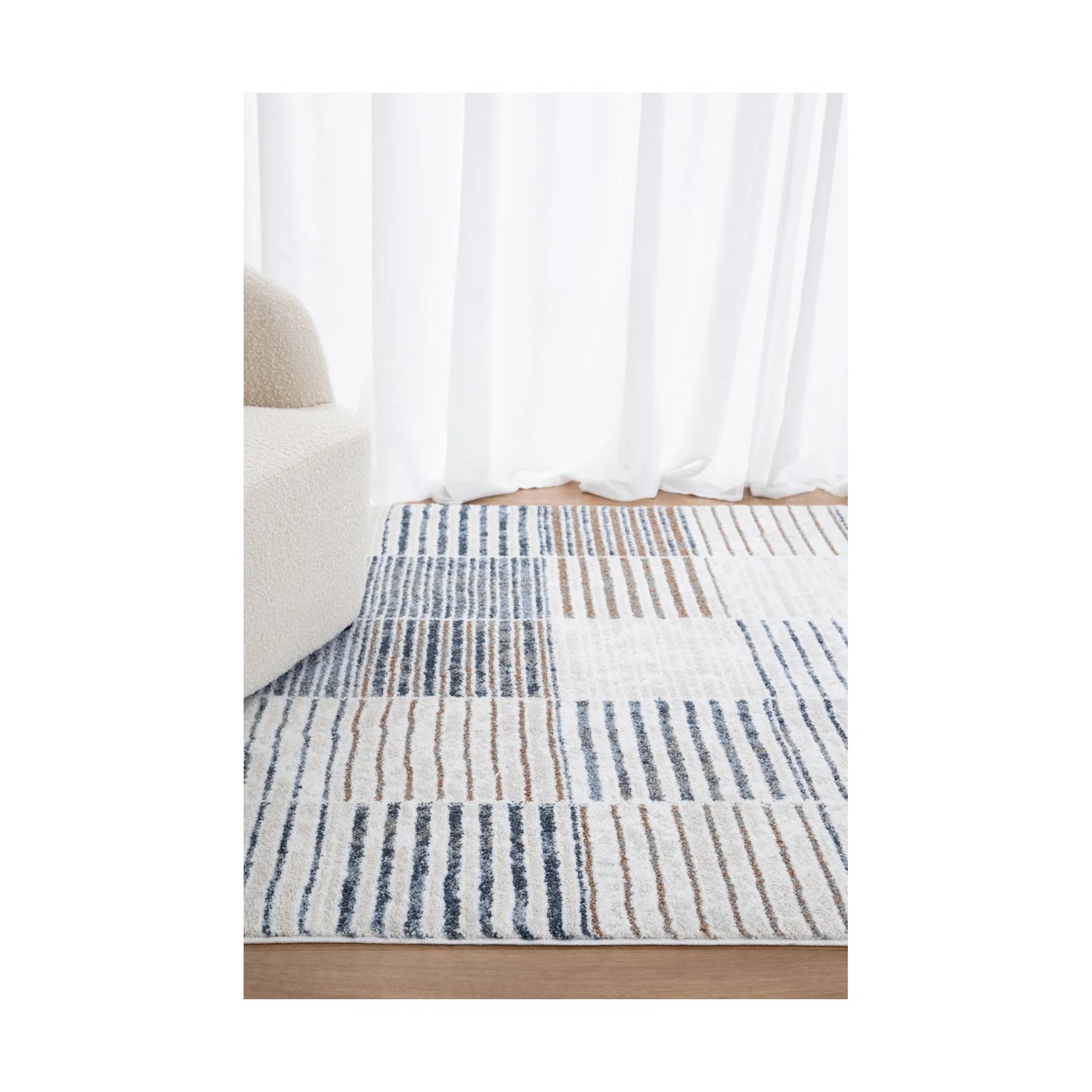 Styled room view of Grace GRAC003 Blue Grey rug showing contemporary block pattern and calm neutral tones, 230 x 160 cm