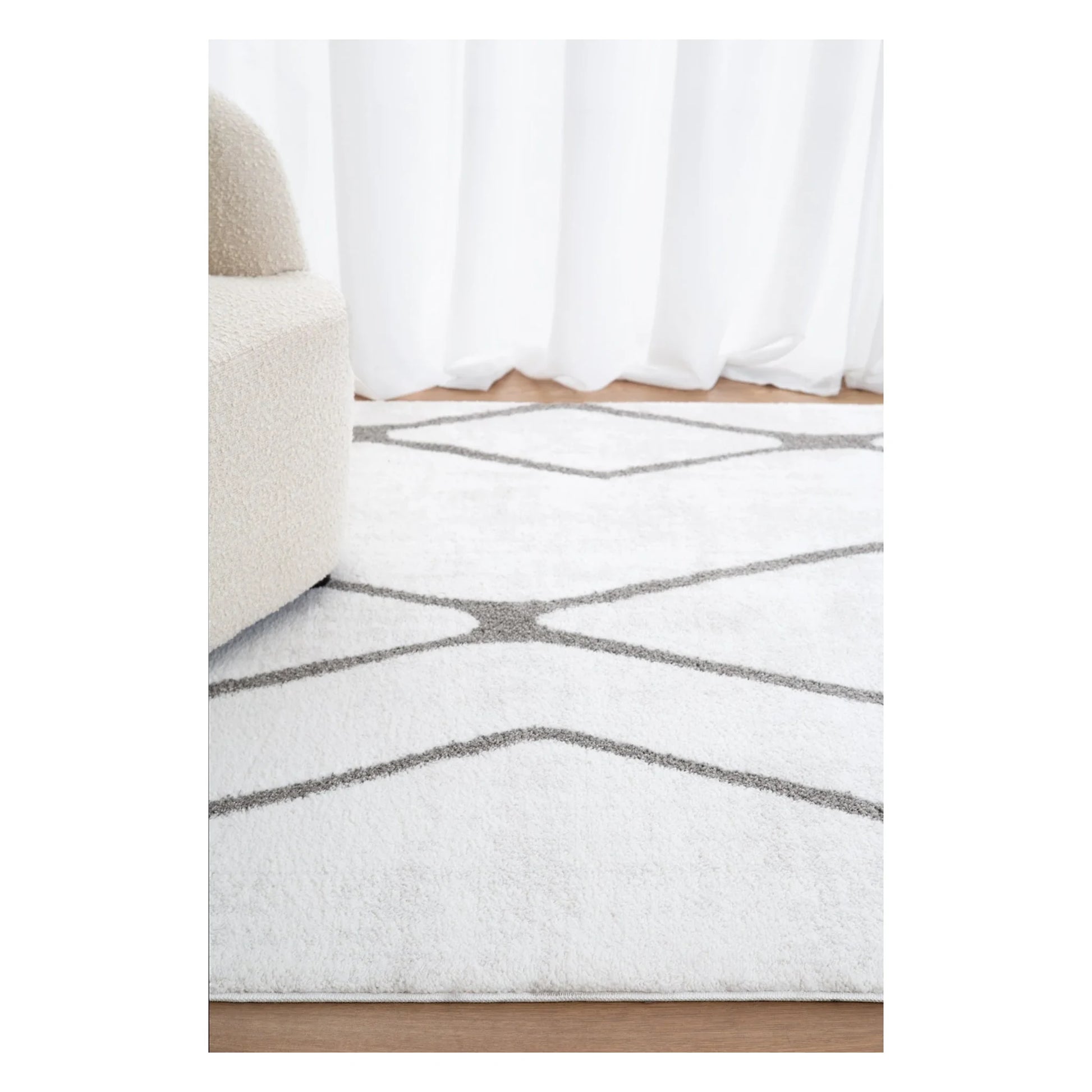 Grace ivory grey trellis rug styled in a bright neutral room