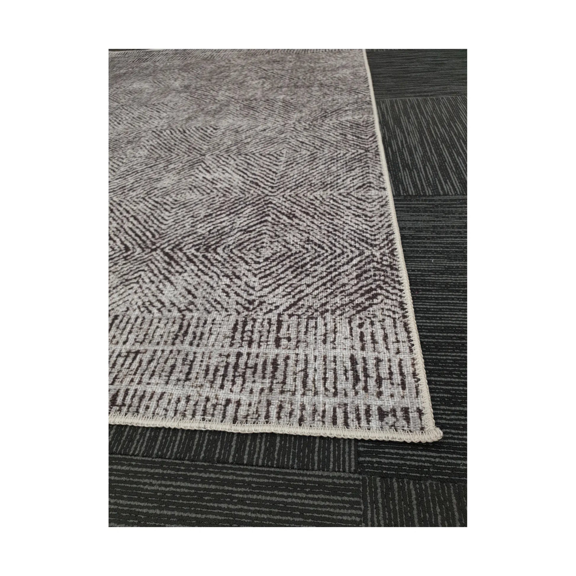 Close-up of grey charcoal chevron cotton rug corner and edge detail