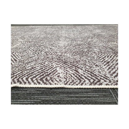 Low-angle close-up of grey charcoal cotton rug edge and woven texture