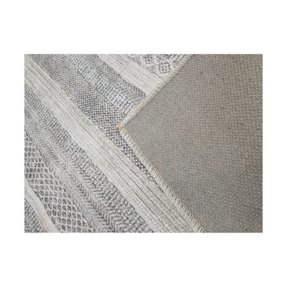 Close-up of grey ivory cotton rug corner with back and edge detail