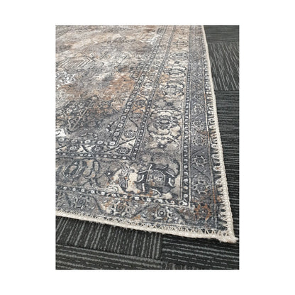 Close-up of grey silver cotton rug corner with ornamental border detail