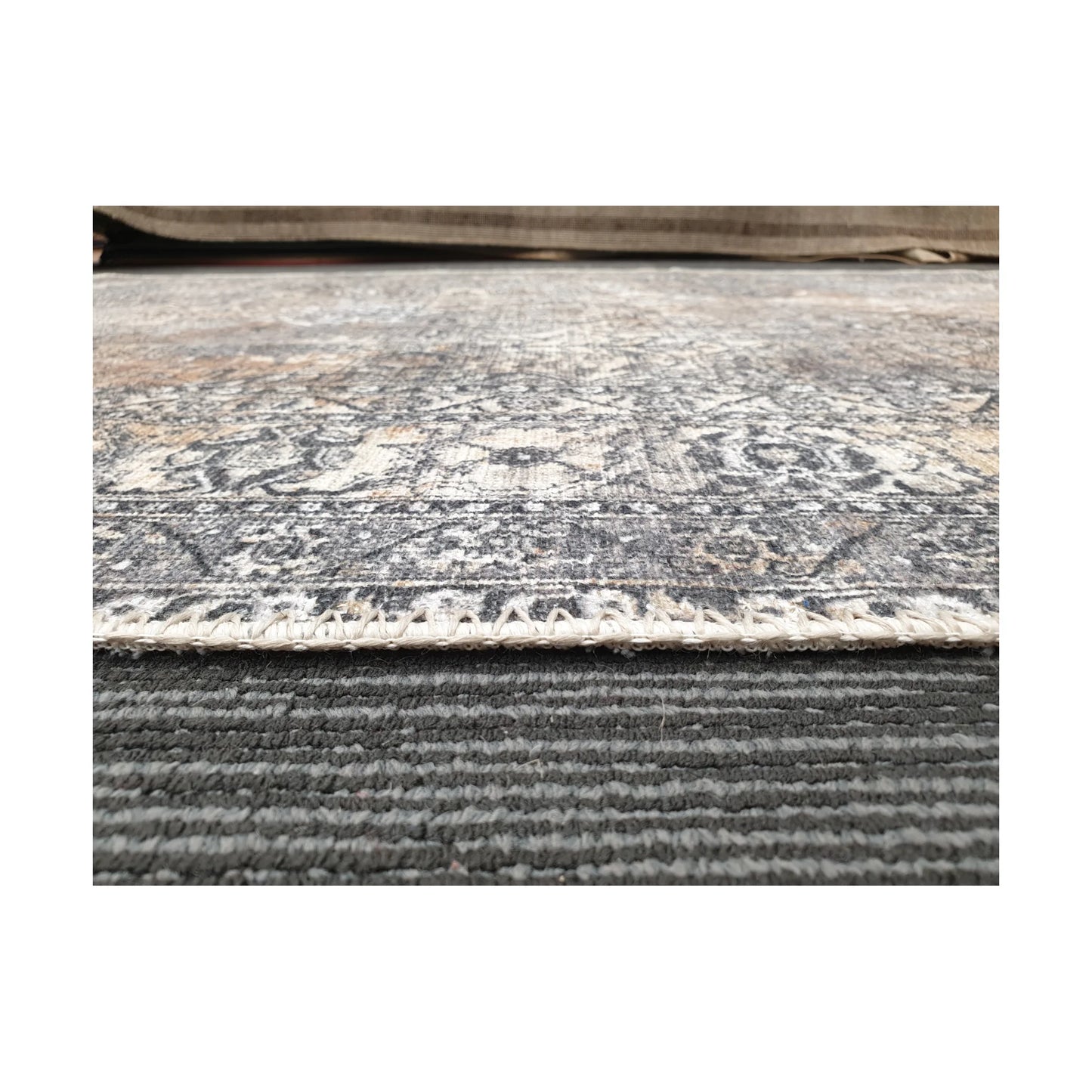 Low-angle detail of cotton rug edge, woven texture and surface finish