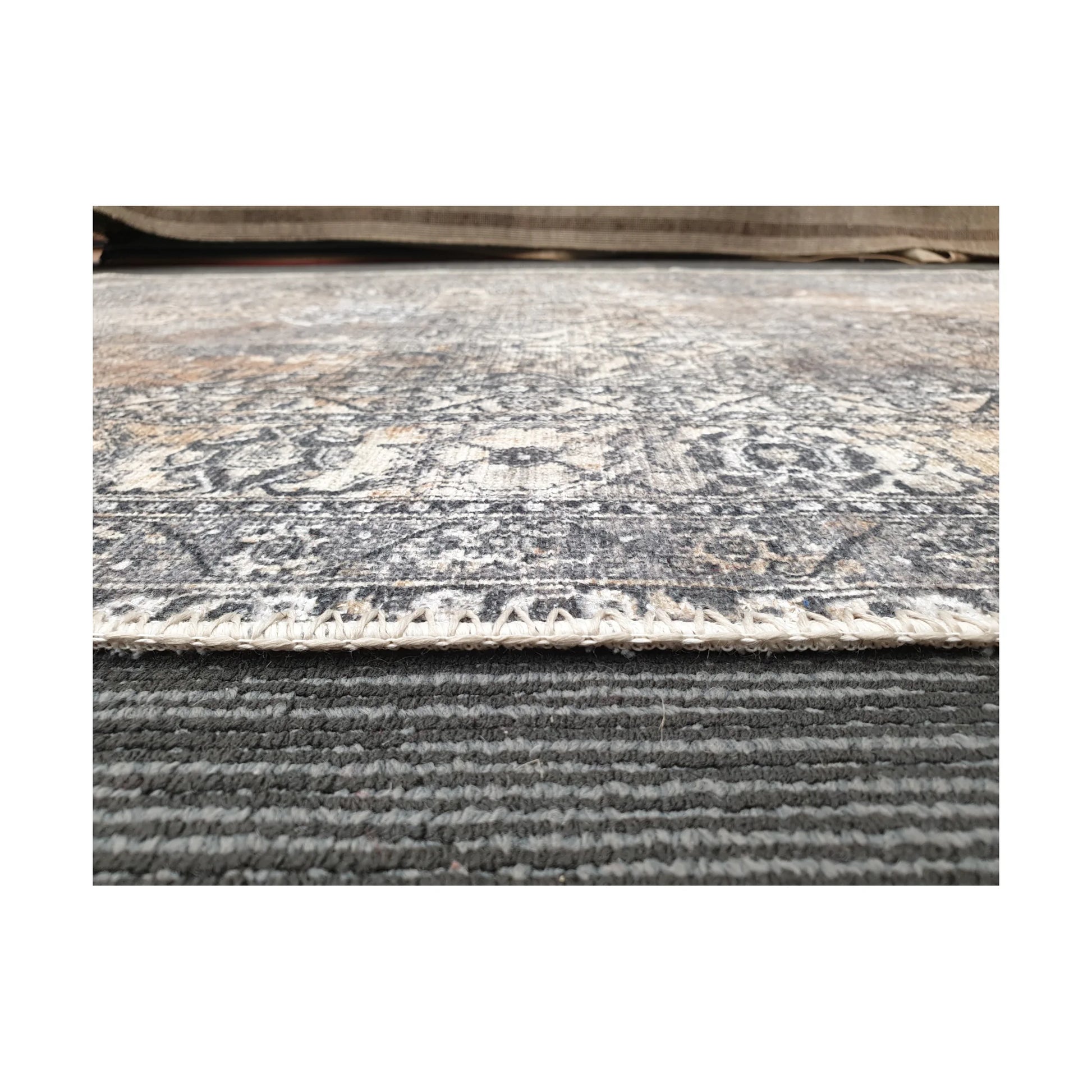 Low-angle detail of cotton rug edge, woven texture and surface finish